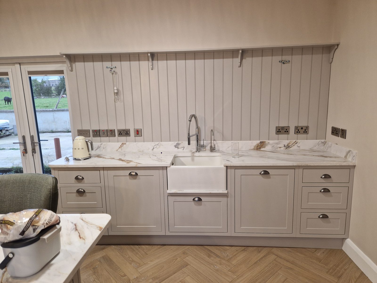 Grey shaker kitchen run with Belfast sink and marble worktop