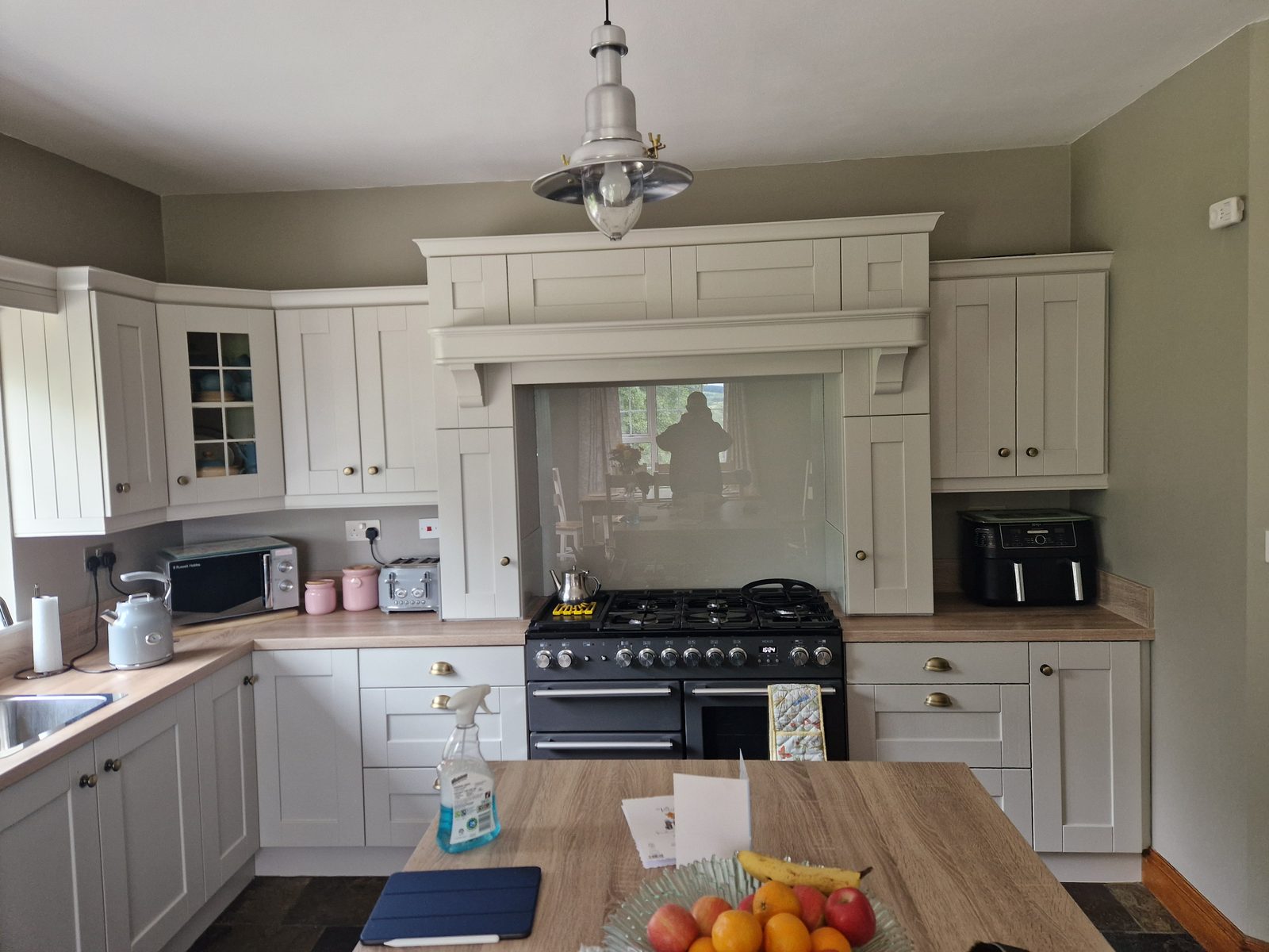 Country shaker kitchen with painted range mantel