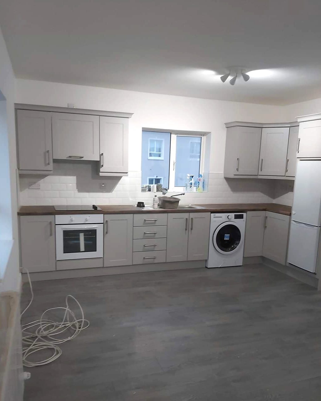 Light grey shaker kitchen with metro tile splashback
